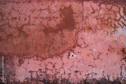 The texture of an old rustic wall is covered with pink stucco photo