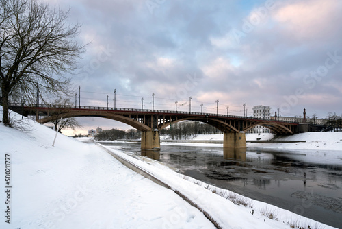 View of the Kirovsky Bridge across the Western Dvina and the embankment along the river on a sunny winter day, Vitebsk, Belarus