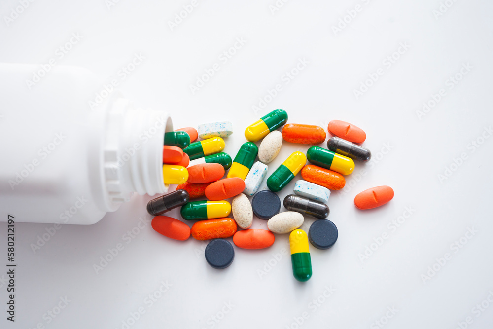 Assorted pharmaceutical medicine pills, tablets and capsules over white background