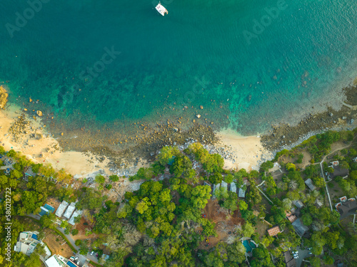 Fototapeta Naklejka Na Ścianę i Meble -  aerial top view Ao Sean small white sand beach lined with rocks..turquoise sea at Ao Sane beach Phuket. 4k colorful blue sea background..beautiful nature in the hidden beach.