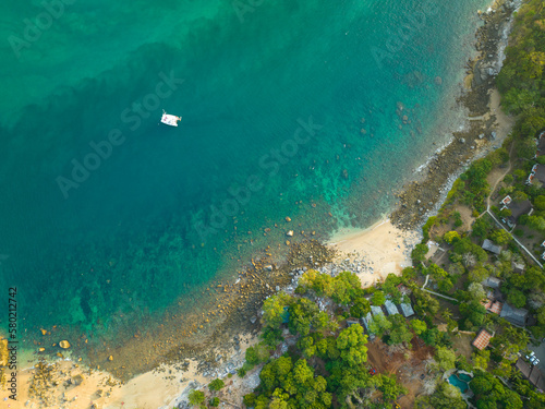 aerial top view Ao Sean small white sand beach lined with rocks..turquoise sea at Ao Sane beach Phuket. 4k colorful blue sea background..beautiful nature in the hidden beach.
