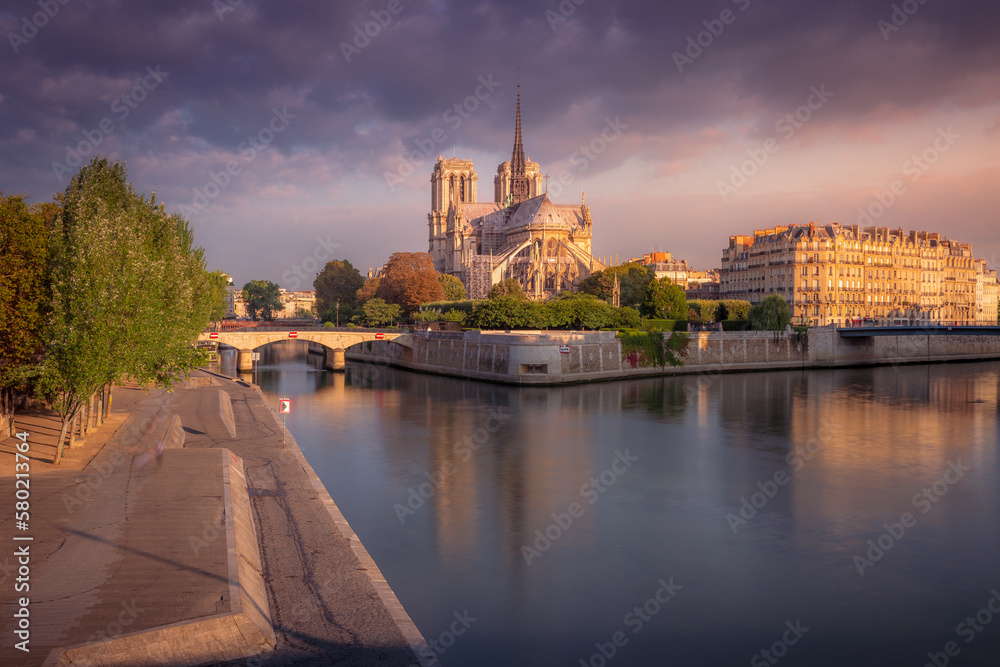 Notre Dame cathedral in Paris at autumn peaceful sunrise, France