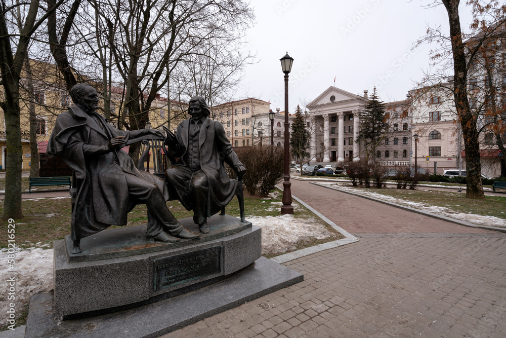Fototapeta premium Monument to the creators of the Belarusian National classical Opera composer Stanislav Monyushko and playwright Vincent Dunin-Marcinkevich in the square near the Town Hall, Minsk, Belarus