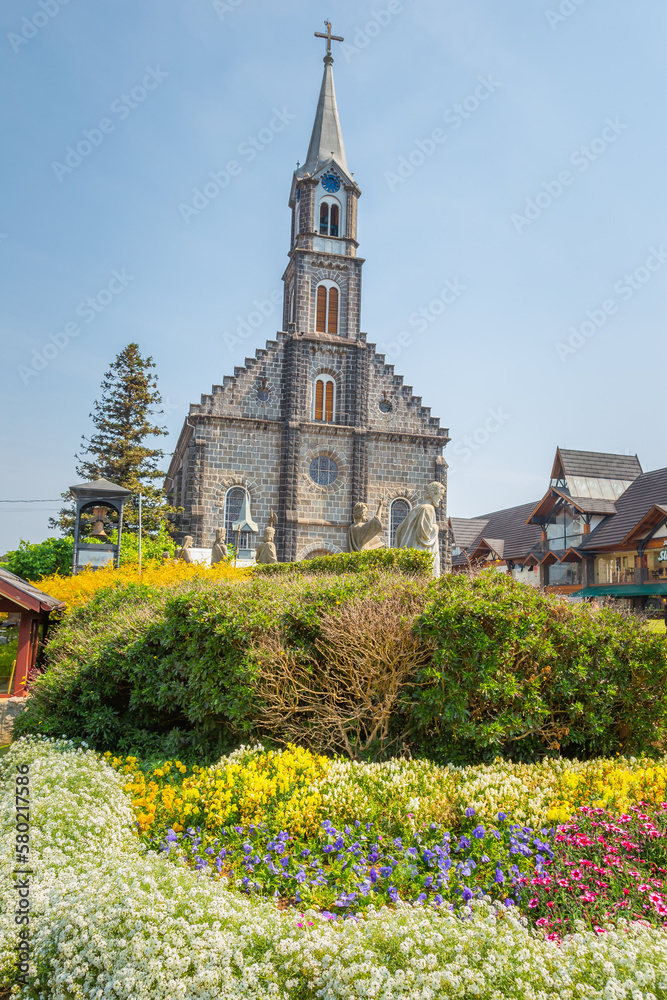 Stone Church with colorful flowerbed, Gramado village, Southern Brazil