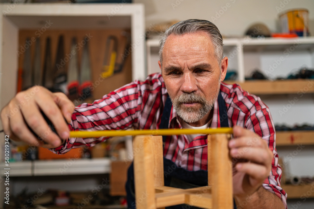 Professional carpenter or craftsmen are using tape measures to measure ...