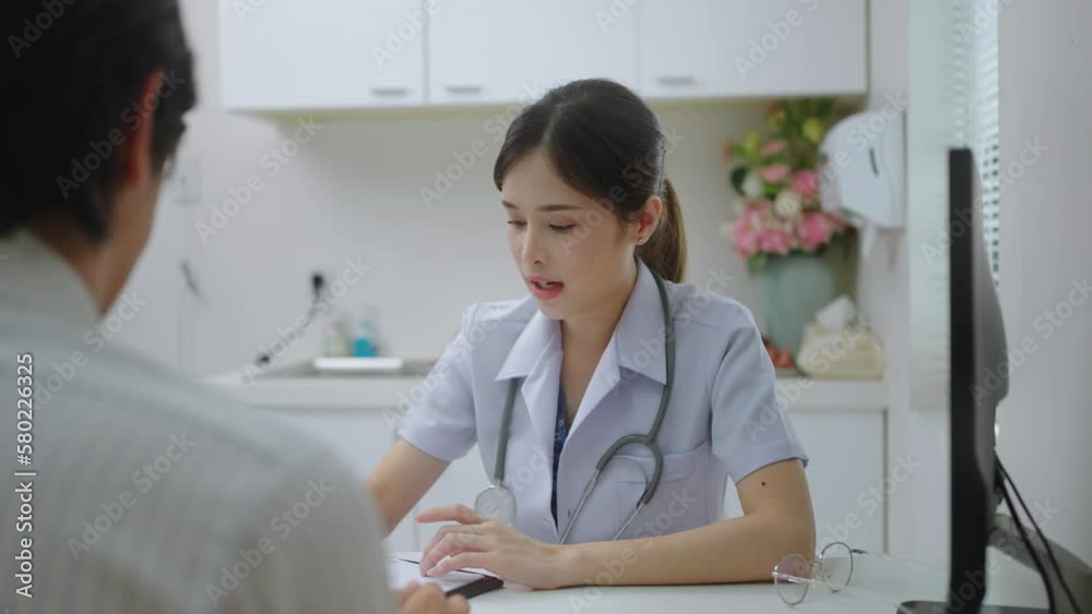 Asian professional woman doctor suggests healthcare solution to her patient in examination room at hospital.male patient explain health problem and symptoms to doctor