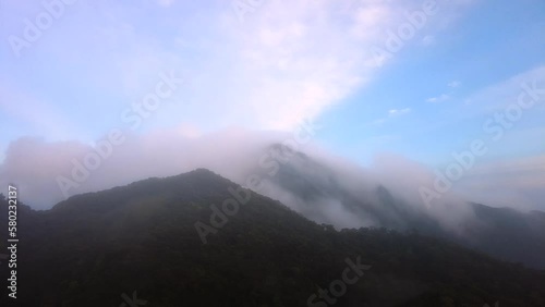 walking trekking on the trail and climb the very mountain in the rain forest with the trees and waterfall and sleep with hammock backpack camping