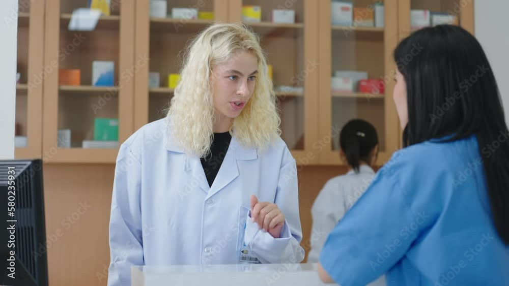 Caucasian woman specialist doctor talking and order with the physician's assistant to pick the medication to patient come to buy medicines at the clinic. Doctor explains of drugs to patient Caucasian woman specialist doctor talking and order with the physician's assistant to pick the medication to patient come to buy medicines at the clinic. Doctor explains of drugs to patient