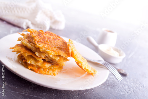 Potato pancakes on white plate on a table photo