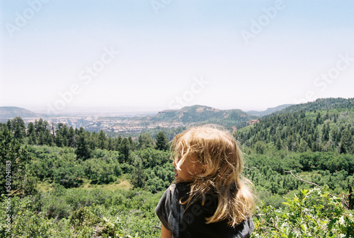 Carefree girl looking at view against clear sky
