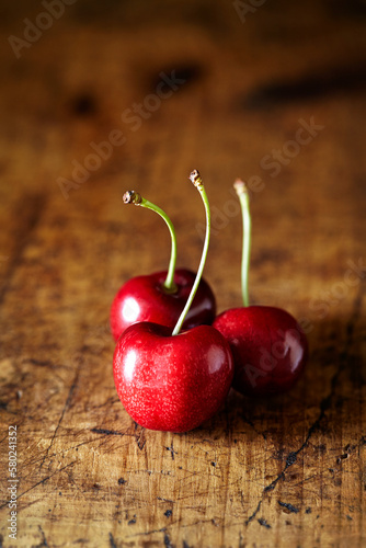 Close-up of cherries on wooden table photo