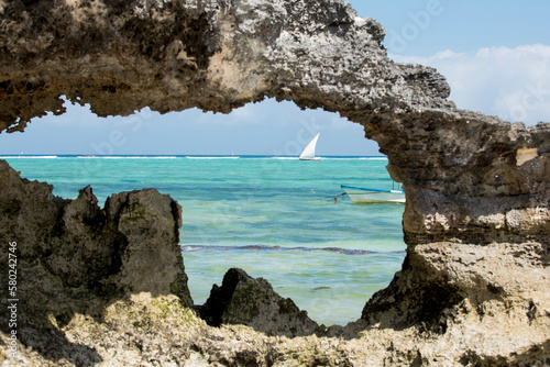 Sea seen through rock formation against sky