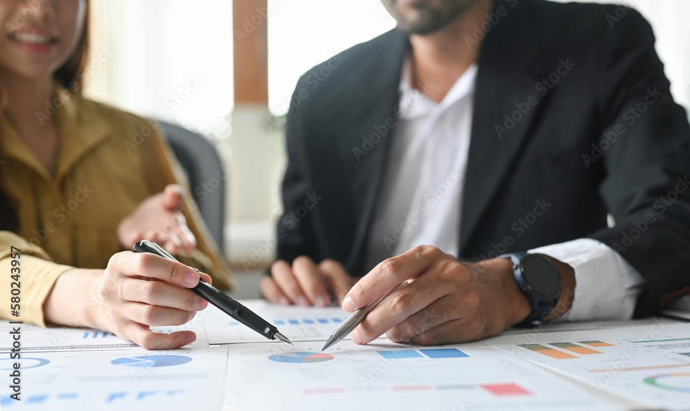 Two financial analyst discussing charts research reports growth and analyzing invest strategy at office. Two financial analyst discussing charts research reports growth and analyzing invest strategy at office.
