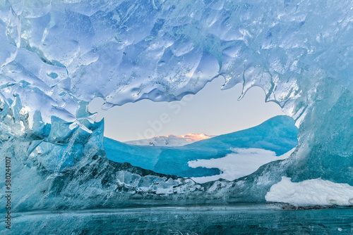 Scenic view of snowcapped mountains seen through glacier photo