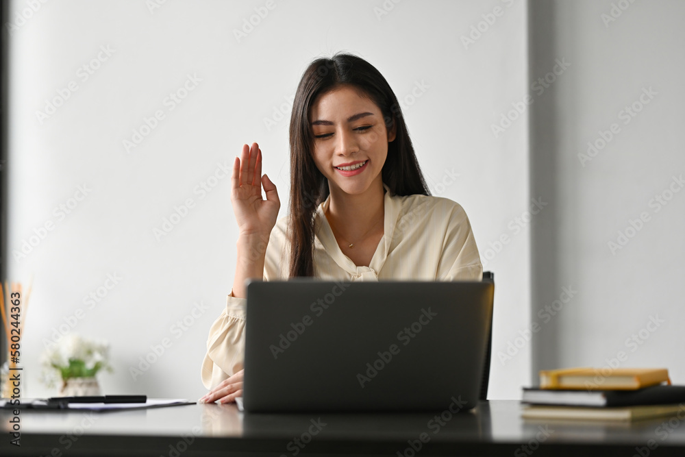 Smiling business woman looking at laptop screen, making business conference video call virtual meeting at office. Smiling business woman looking at laptop screen, making business conference video call virtual meeting at office.