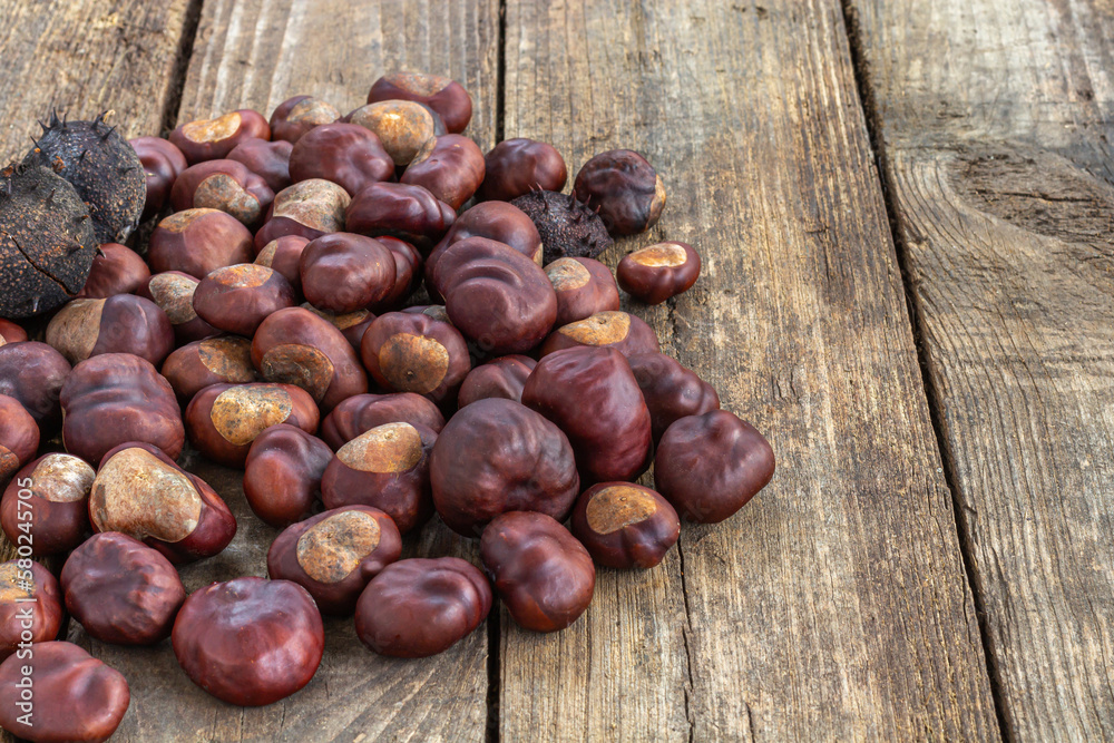 Roasted sweet chestnuts on grey rustic wooden table. Roasted sweet chestnuts on grey rustic wooden table.