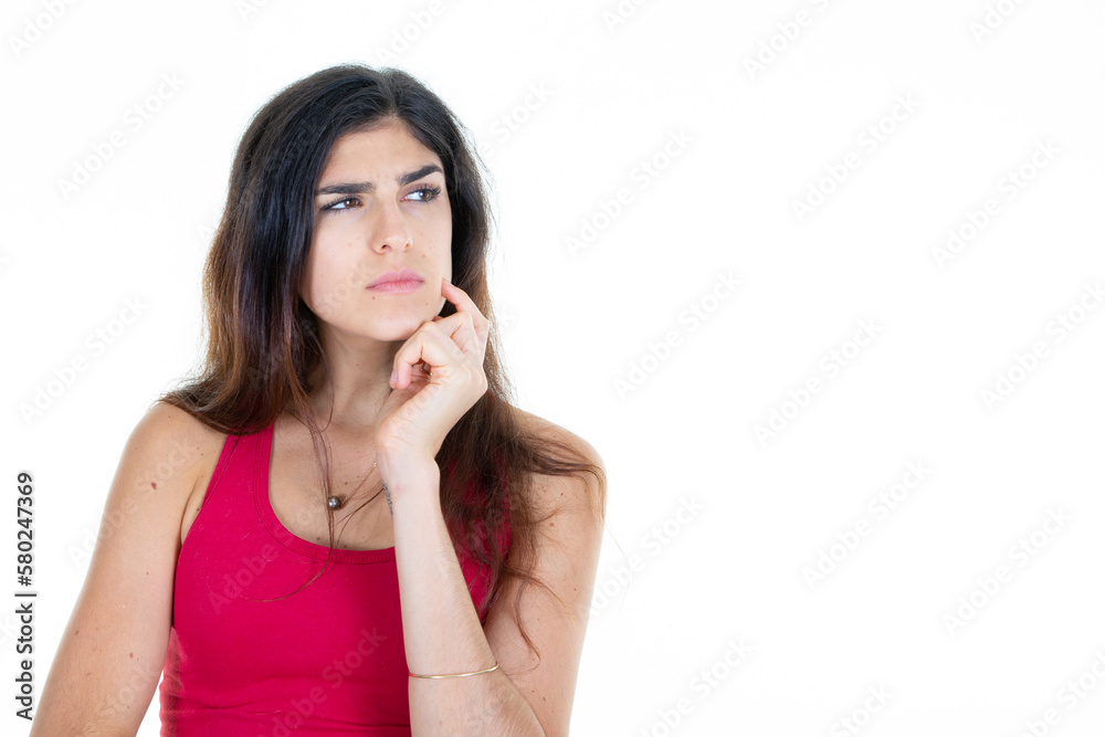 brunette woman thinking looks side hand on chin looking aside copy space empty white background brunette woman thinking looks side hand on chin looking aside copy space empty white background