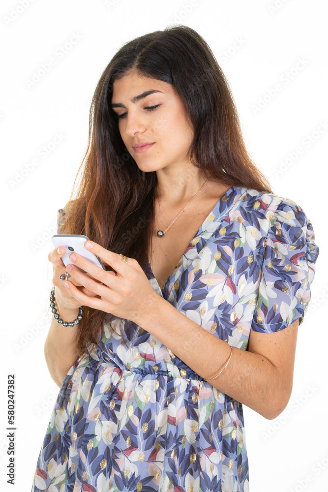 Portrait of smiling young brunette spanish woman using texting looking mobile phone on white background Portrait of smiling young brunette spanish woman using texting looking mobile phone on white background