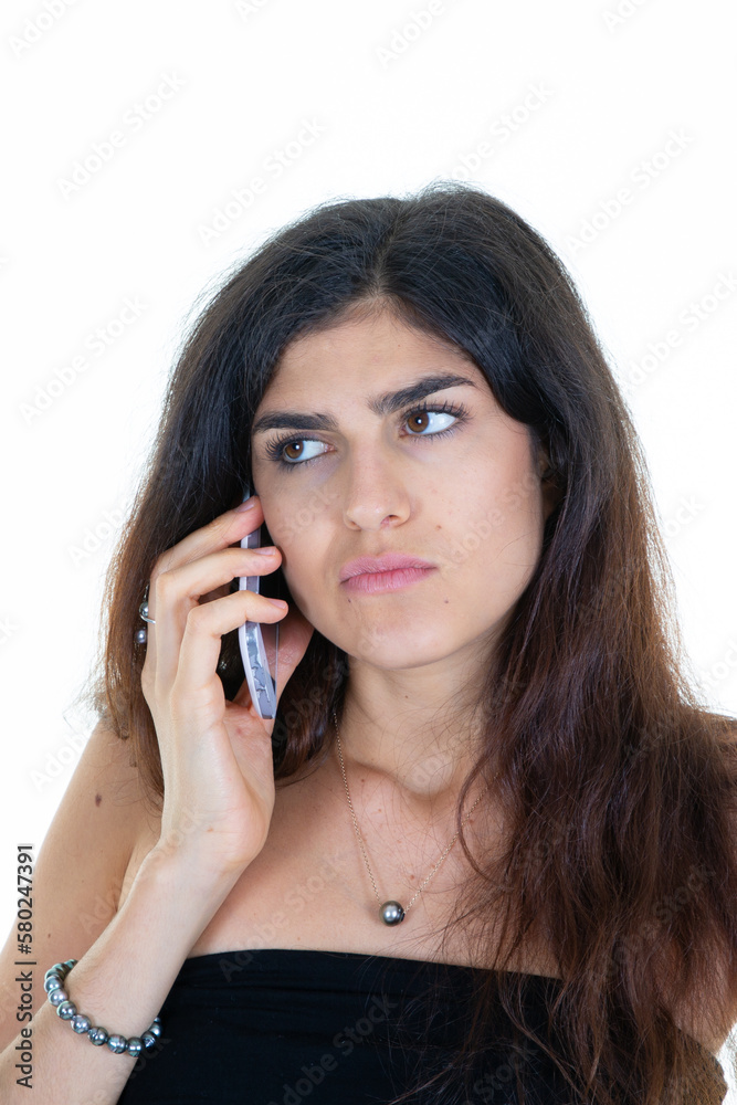 Portrait of beautiful young pretty woman sad pensive talk on cell phone isolated on white background Portrait of beautiful young pretty woman sad pensive talk on cell phone isolated on white background