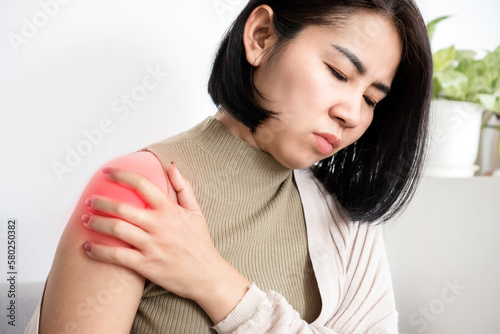 Asian woman suffering from frozen shoulder with pain and stiffness, Rotator cuff tear concept