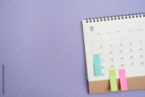 close up of calendar on the violet table background, planning for business meeting or travel planning concept