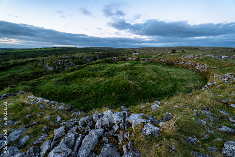 The unique Cahercommaun triple ring fort is situated on the edge of an inland cliff facing, The Burren National Park, County Clare, Ireland