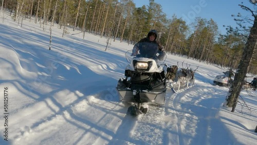 Western Siberia, Khanty people on snowmobiles take deer to the taiga.