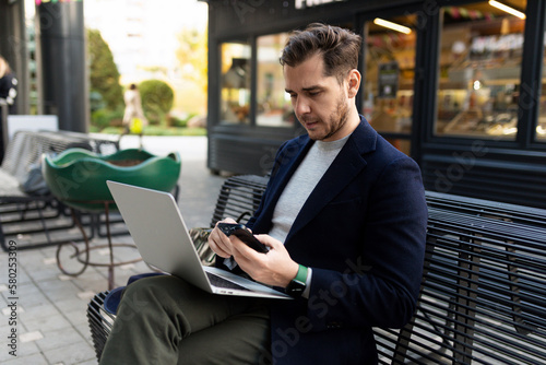 portrait of a confident European businessman holding a laptop in his hands