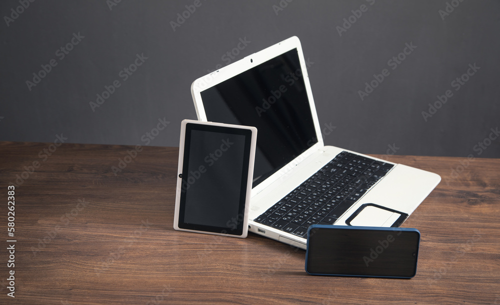 Smartphone, tablet, laptop computer on the wooden table. Smartphone, tablet, laptop computer on the wooden table.