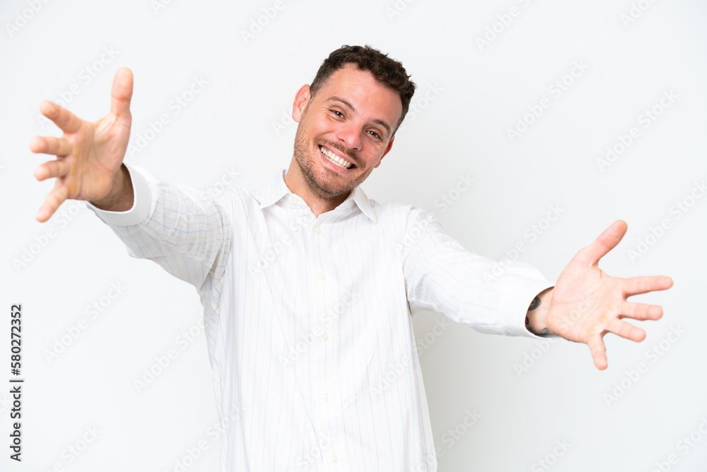 Young caucasian handsome man isolated on white background presenting and inviting to come with hand Young caucasian handsome man isolated on white background presenting and inviting to come with hand