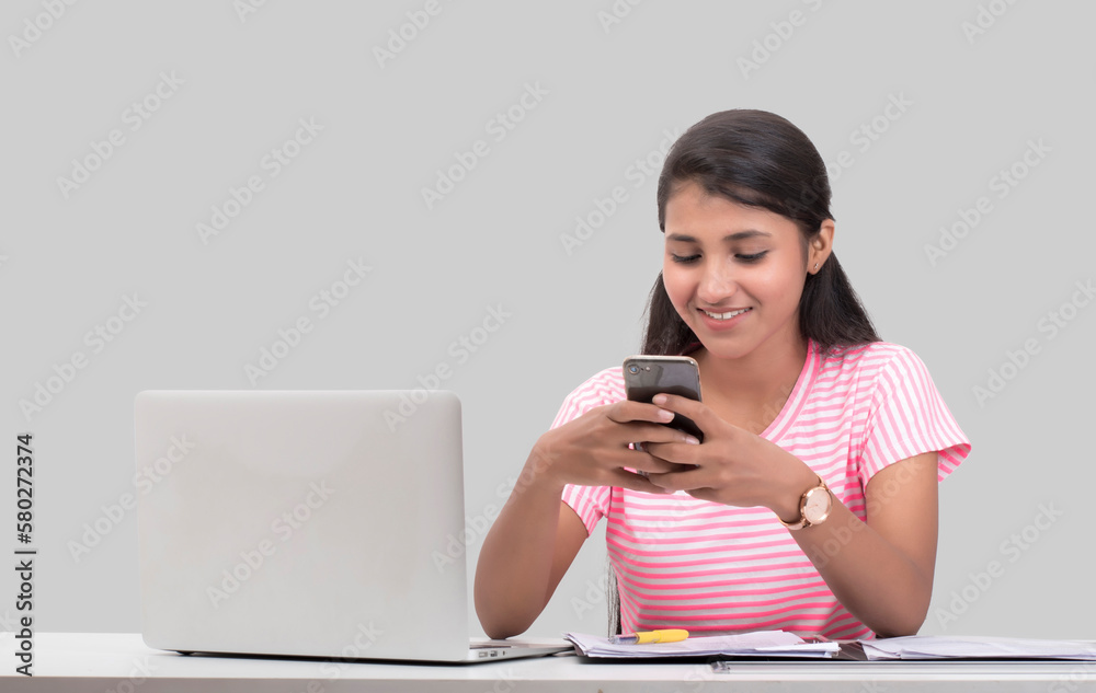 woman working on alptop and using mobile phone woman working on alptop and using mobile phone