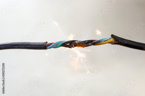 flame smoke and sparks on an electrical cable, fire hazard concept photo