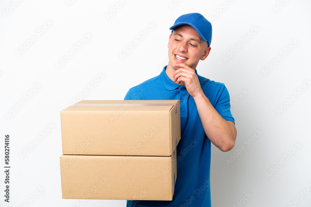 Young delivery Brazilian man isolated ops white background looking to the side and smiling Young delivery Brazilian man isolated ops white background looking to the side and smiling
