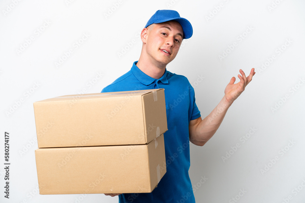 Young delivery Brazilian man isolated ops white background extending hands to the side for inviting to come Young delivery Brazilian man isolated ops white background extending hands to the side for inviting to come