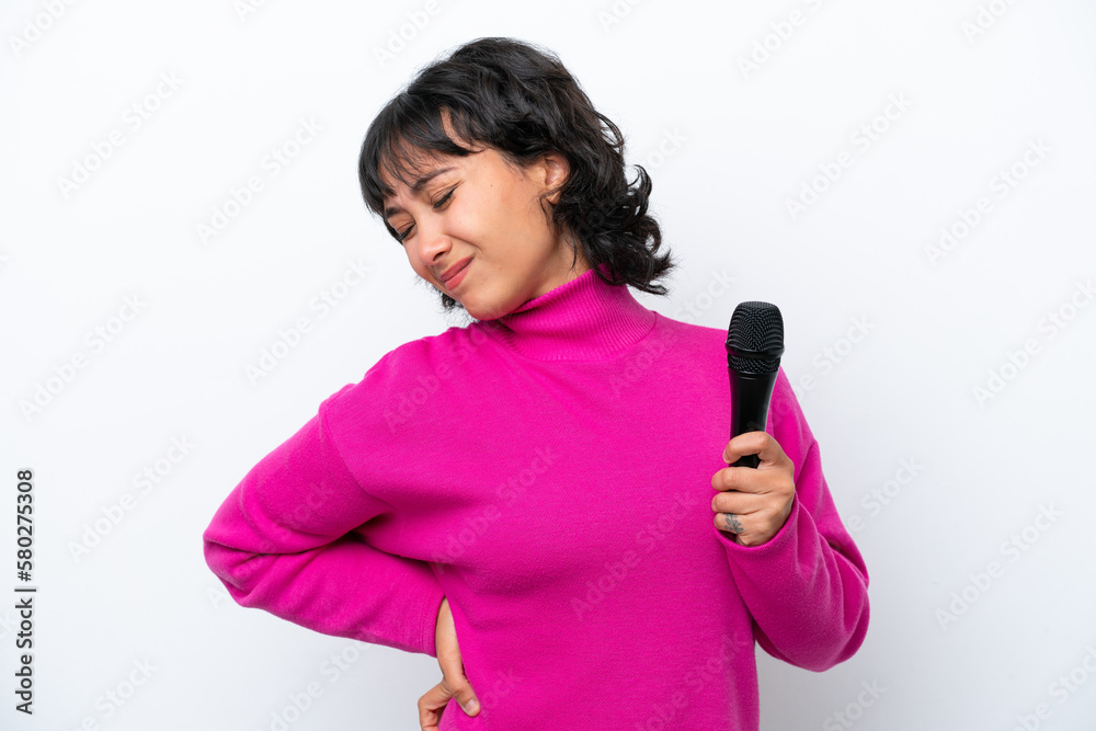 Young Argentinian singer woman isolated on white background suffering from backache for having made an effort Young Argentinian singer woman isolated on white background suffering from backache for having made an effort