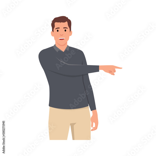 Young man standing looking at camera and pointing with two hands and fingers to side.