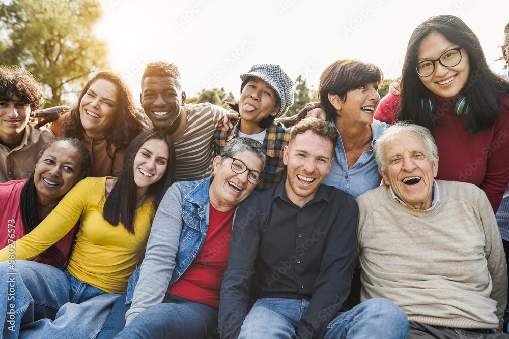Group of multigenerational people smiling in front of camera - Multiracial friends od different ages having fun together - Main focus on caucasian senior faces - obrazy, fototapety, plakaty 
