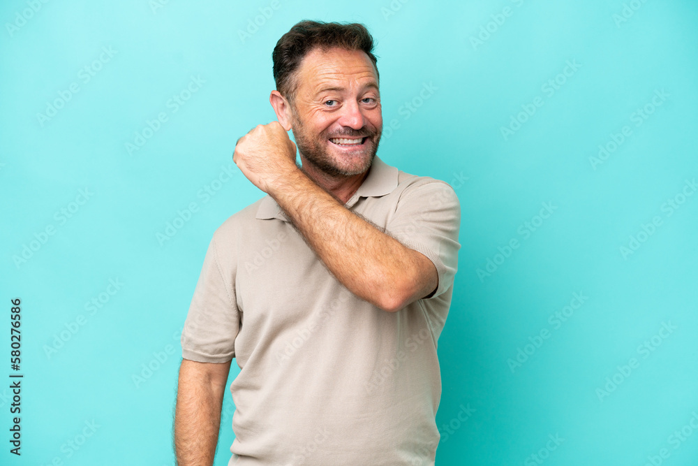 Middle age caucasian man isolated on blue background celebrating a victory Middle age caucasian man isolated on blue background celebrating a victory