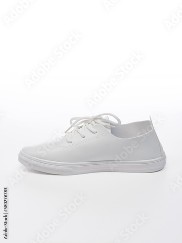 Leather sport shoes on a white background. Isolated white sneaker with shadow