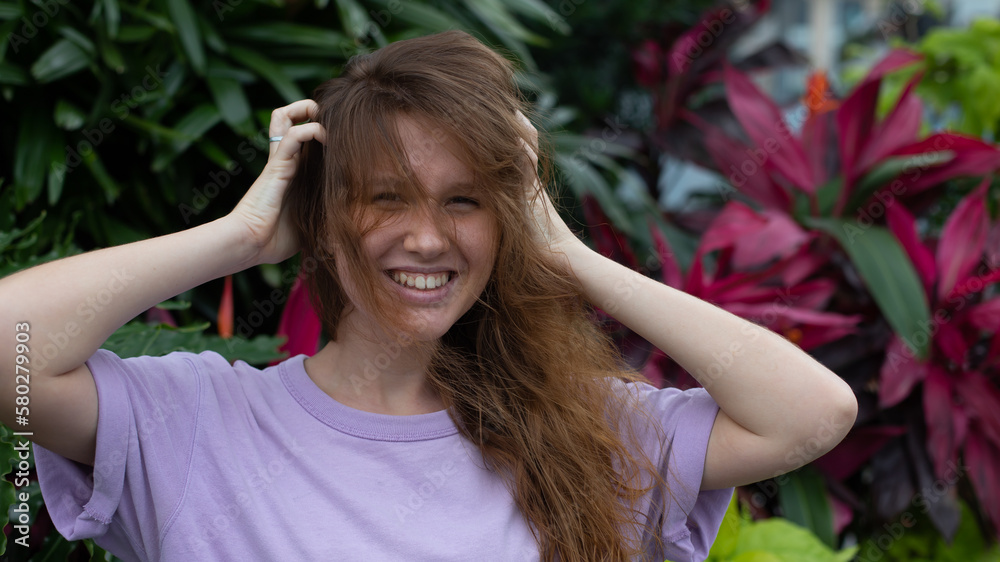 portrait of young girl on a green, natural background, eco friendly woman in a tropical park or jungle, positive lady enjoys walk at garden at summer day portrait of young girl on a green, natural background, eco friendly woman in a tropical park or jungle, positive lady enjoys walk at garden at summer day