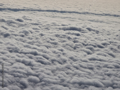 View of clouds from the window of a flying plane on a sunny spring day  France  Europe.