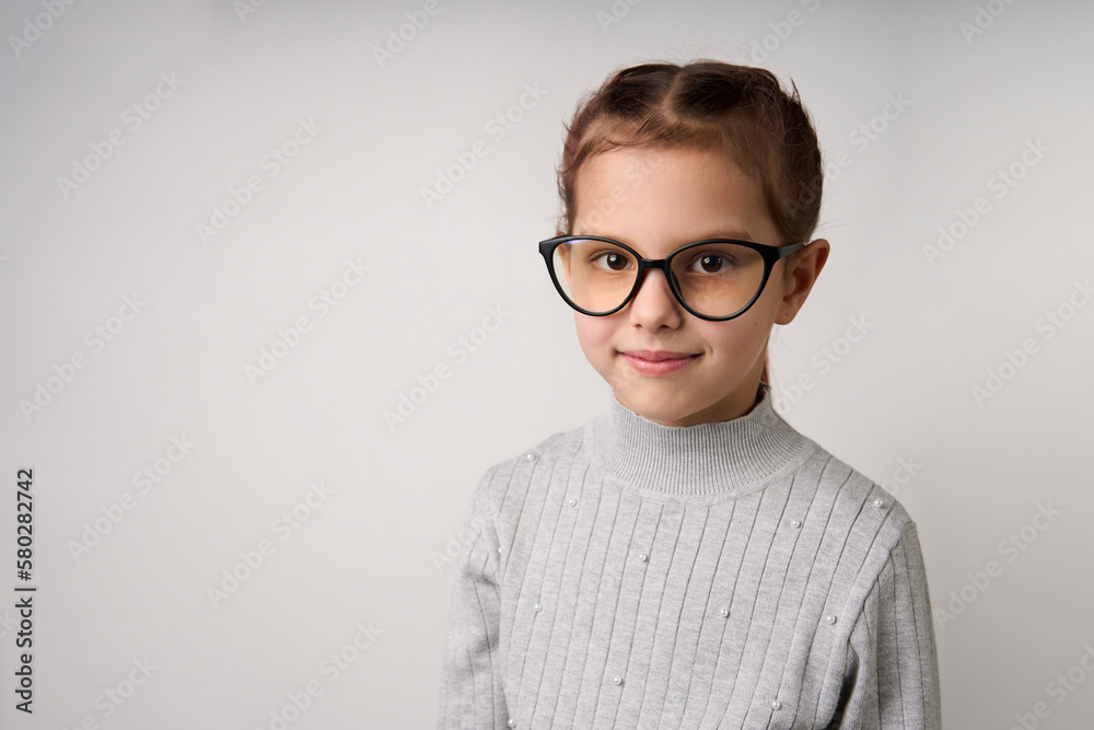 Smiling child girl wearing glasses. Smart girl portrait