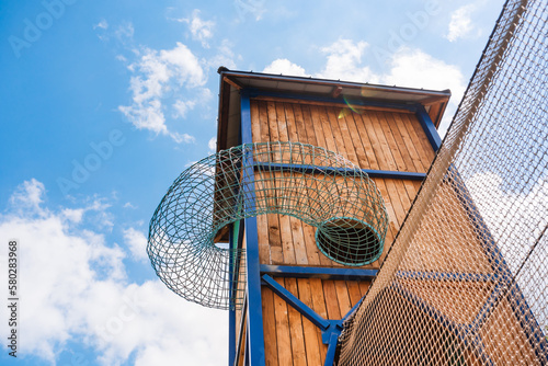 Wooden tower with climbing nets in an adventure amusement park. photo