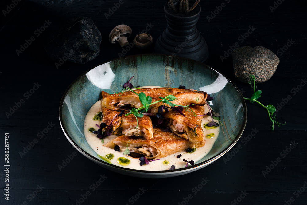 Fried thin pancakes with ham, cheese, mushrooms and sauce. Fried thin pancakes with ham, cheese, mushrooms and sauce.