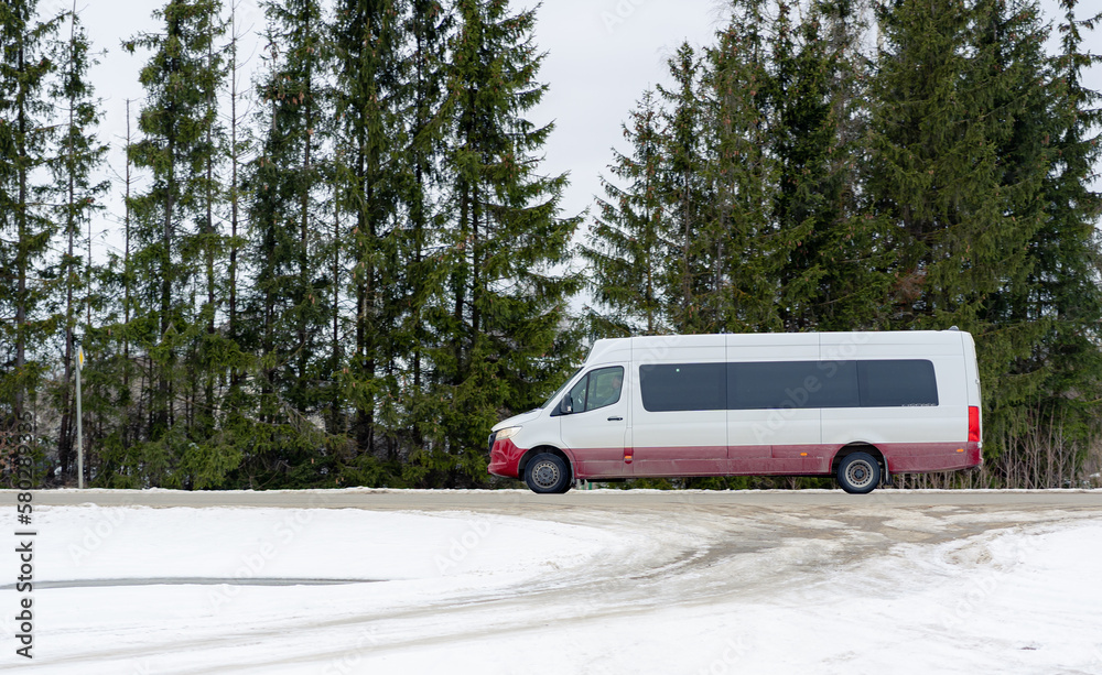 Fototapeta premium An intercity passenger express bus is driving along the highway