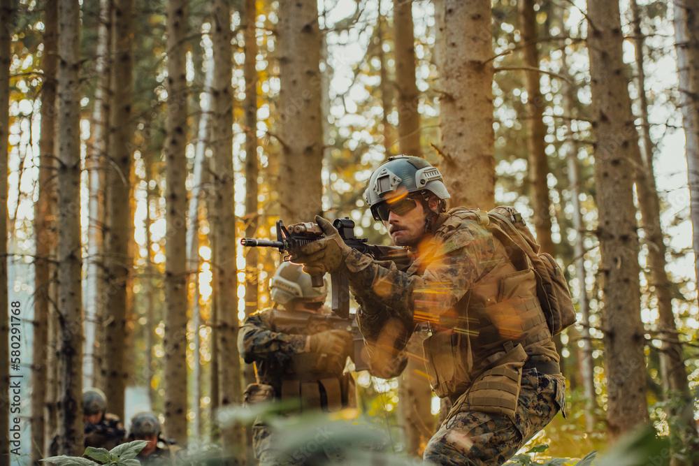 A group of modern warfare soldiers is fighting a war in dangerous remote forest areas. A group of soldiers is fighting on the enemy line with modern weapons. The concept of warfare and military A group of modern warfare soldiers is fighting a war in dangerous remote forest areas. A group of soldiers is fighting on the enemy line with modern weapons. The concept of warfare and military