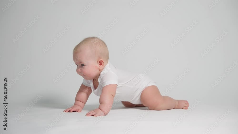 A small child learning to crawl , the concept of child development and health