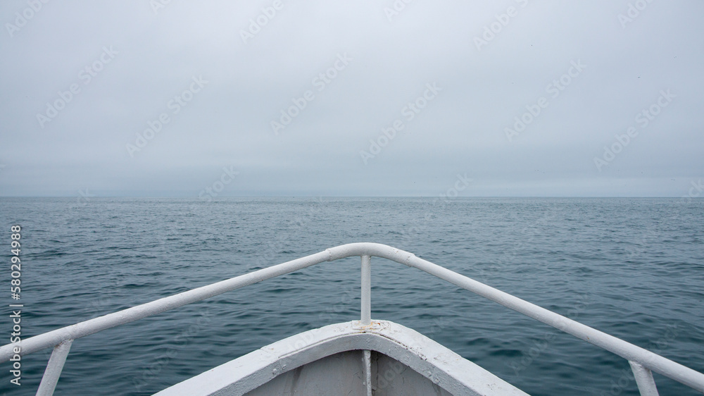 On the bow of the boat. Along the coast of the Kamchatka On the bow of the boat. Along the coast of the Kamchatka