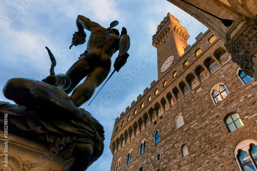 Firenze. Scultura della Medusa del Cellini alla Loggia dei Lanzi con la Torre di arnolfo di palazzo della Signoria. photo