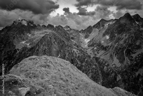Trekking in the mountainous landscape high above the Valasco valley, Valle di Valasco, with dramatic clouds, black and white photo, Cottian Alps, Maritime Alps, Western Alps, Italy, Europe